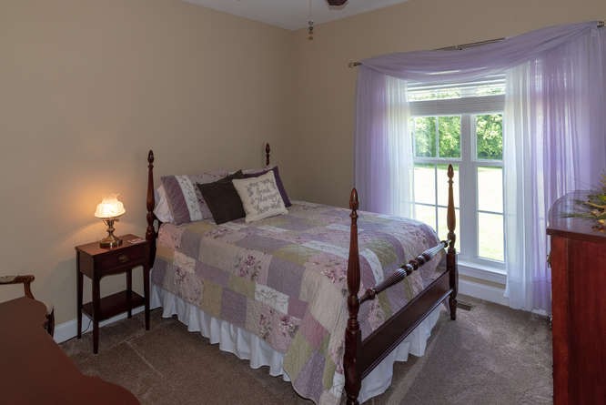 1997 Clara Mathis Road Spring Hill, TN 37174 - Photo 32 of 47 a bed sitting in a bedroom next to a window