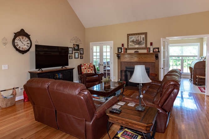 1997 Clara Mathis Road Spring Hill, TN 37174 - Photo 10 of 47 a living room with furniture a flat screen tv and wooden floor