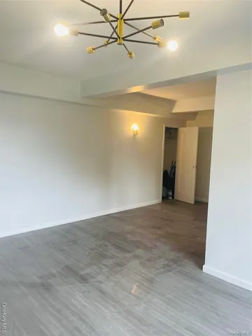 an empty room and chandelier fan view