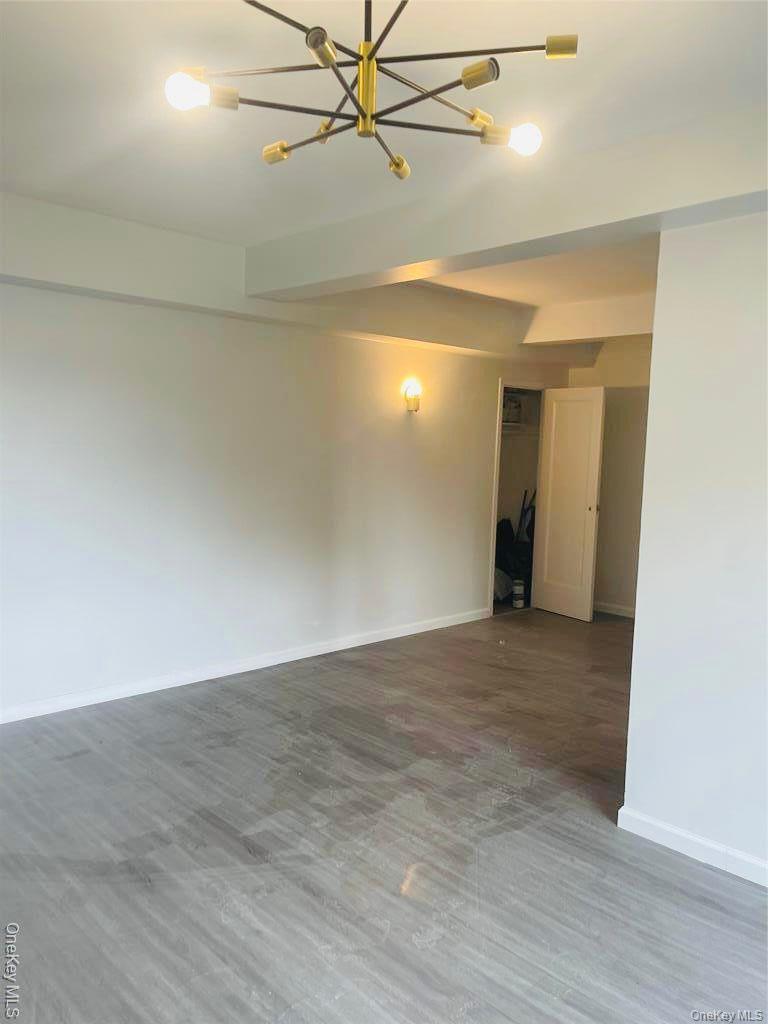 5-metropolitan Oval, Unit 4H Bronx, NY 10462 - Photo 3 of 4 an empty room and chandelier fan view