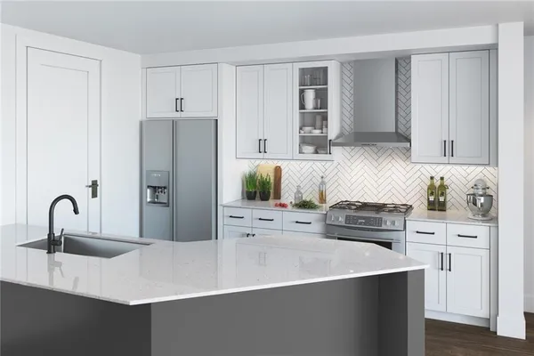 a kitchen with stainless steel appliances a sink a stove and cabinets