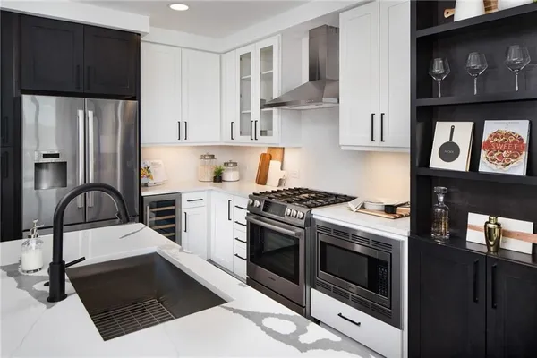 a kitchen with stainless steel appliances a stove a refrigerator and cabinets