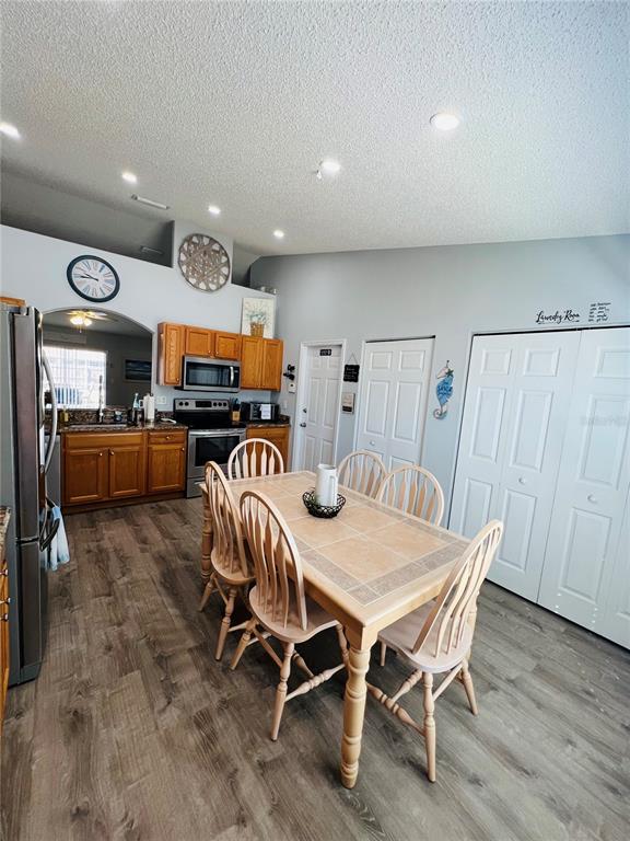 8 Firethorn Lane Palm Coast, FL 32137 - Photo 13 of 28 a dining room with furniture and wooden floor