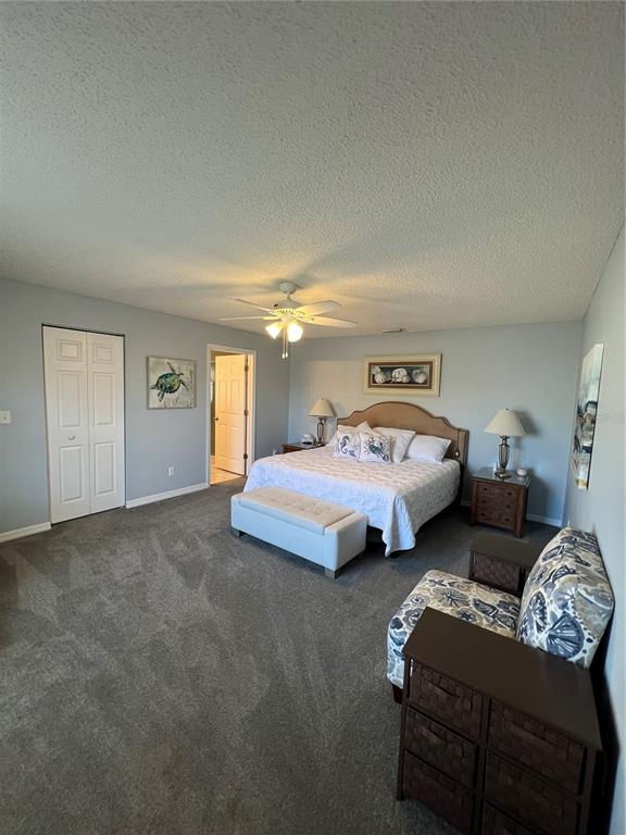8 Firethorn Lane Palm Coast, FL 32137 - Photo 14 of 28 a spacious bedroom with two beds and a couch
