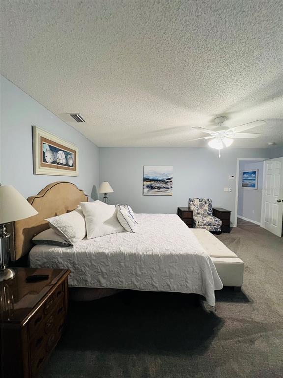 8 Firethorn Lane Palm Coast, FL 32137 - Photo 16 of 28 a bedroom with a bed and a night stand