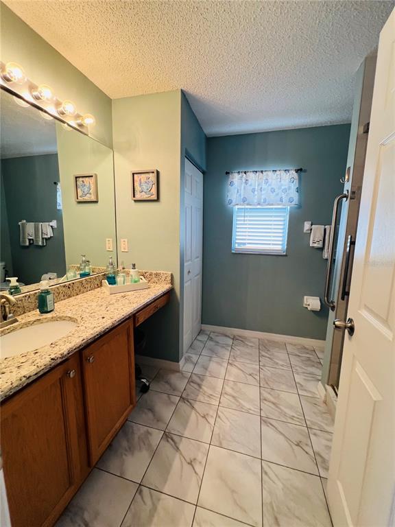 8 Firethorn Lane Palm Coast, FL 32137 - Photo 17 of 28 a bathroom with a sink a vanity and a mirror