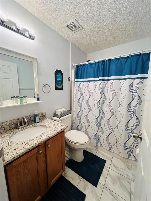 8 Firethorn Lane Palm Coast, FL 32137 - Photo 23 of 28 a bathroom with a granite countertop sink and a mirror