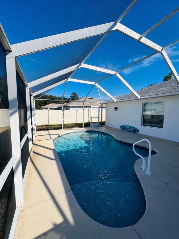 8 Firethorn Lane Palm Coast, FL 32137 - Photo 26 of 28 a view of a swimming pool with a patio