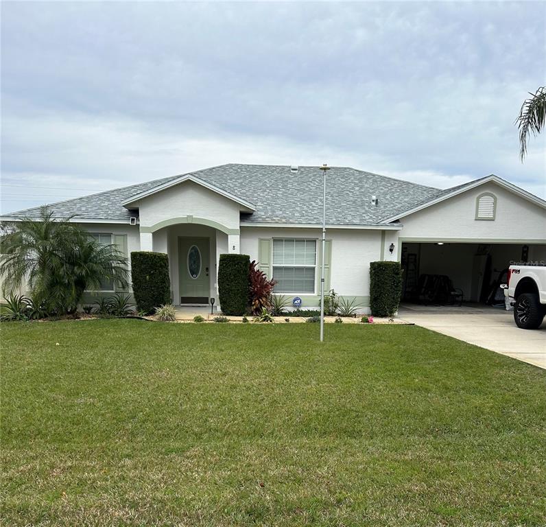 8 Firethorn Lane Palm Coast, FL 32137 - Photo 28 of 28 a front view of a house with a garden and trees