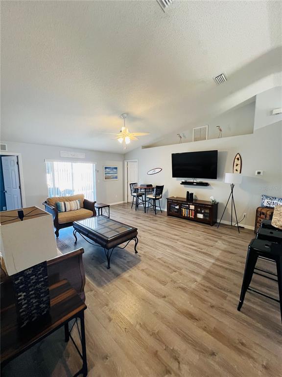 8 Firethorn Lane Palm Coast, FL 32137 - Photo 4 of 28 a living room with furniture a flat screen tv and a window