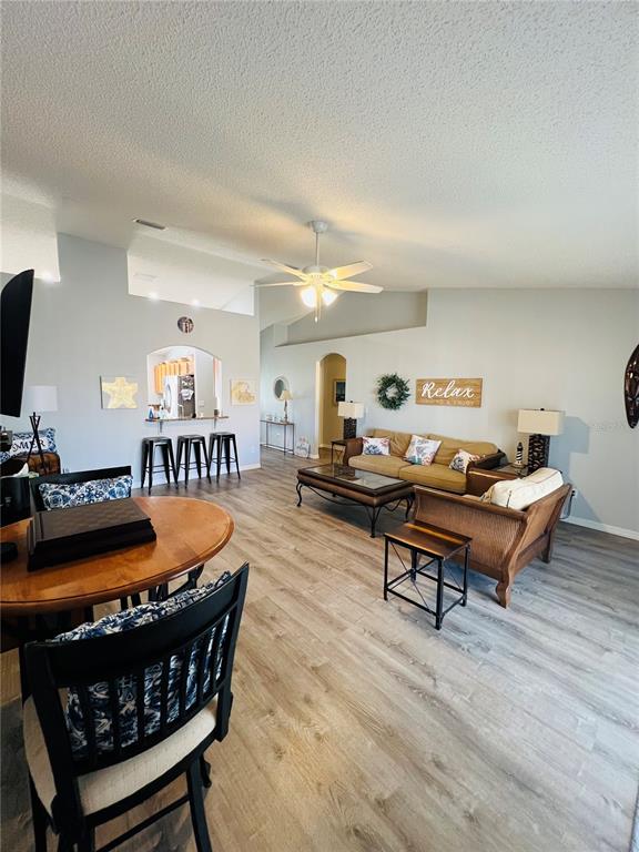 8 Firethorn Lane Palm Coast, FL 32137 - Photo 5 of 28 a living room with furniture a wooden floor and a table