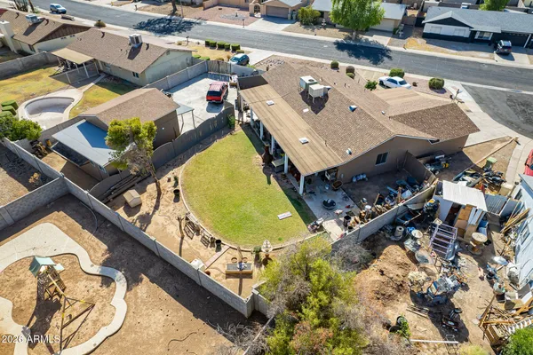 an aerial view of a swimming pool with outdoor seating