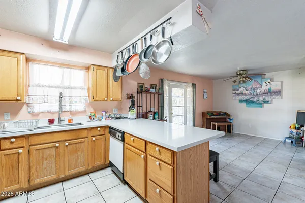 a dining room with furniture and a kitchen view