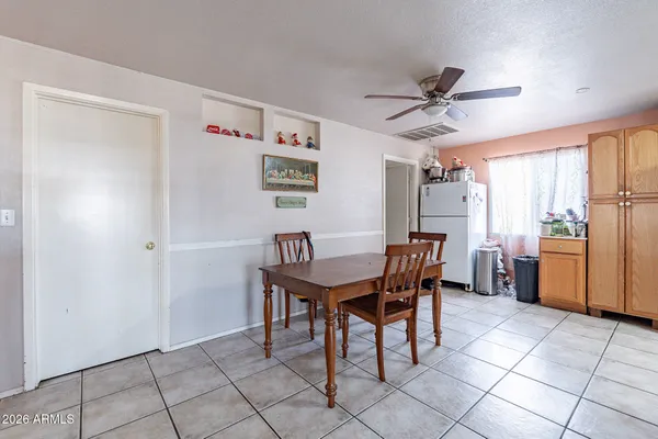 a kitchen with stainless steel appliances granite countertop a stove a sink dishwasher a dining table and chairs with a dining table