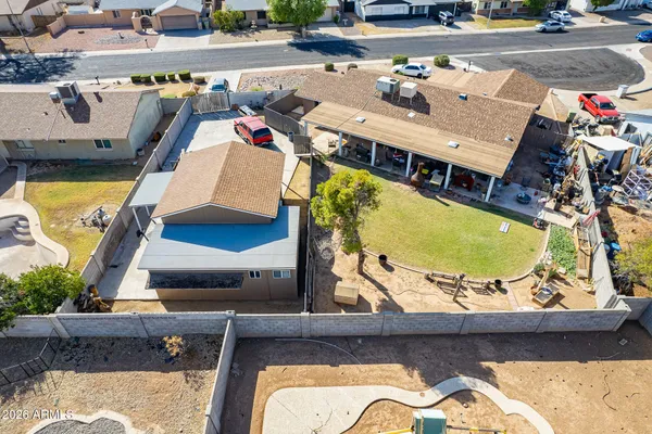 an aerial view of a swimming pool with outdoor seating