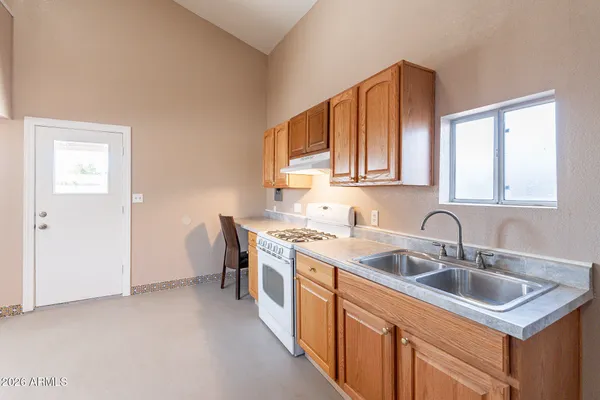 a view of a kitchen with a sink cabinets and a refrigerator