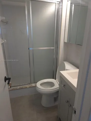 a white toilet sitting next to a bathroom sink