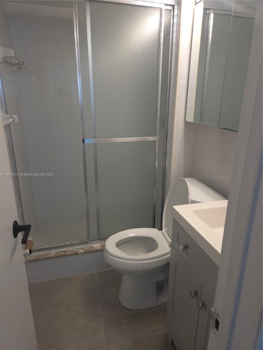 467 Golden Isles Drive, Unit 110 Hallandale Beach, FL 33009 - Photo 2 of 11 a white toilet sitting next to a bathroom sink