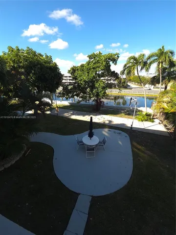 a view of a swimming pool with an outdoor space and seating area