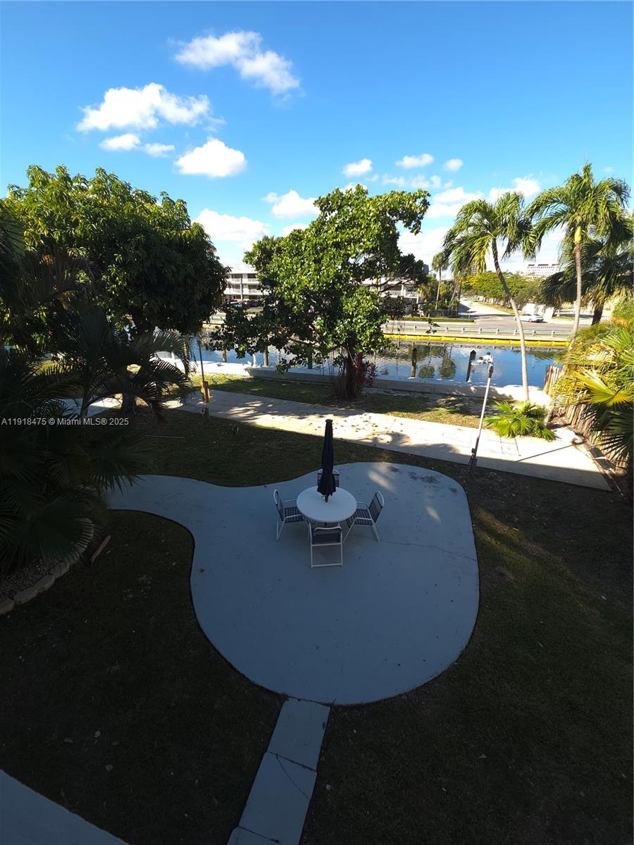 467 Golden Isles Drive, Unit 110 Hallandale Beach, FL 33009 - Photo 4 of 11 a view of a swimming pool with an outdoor space and seating area