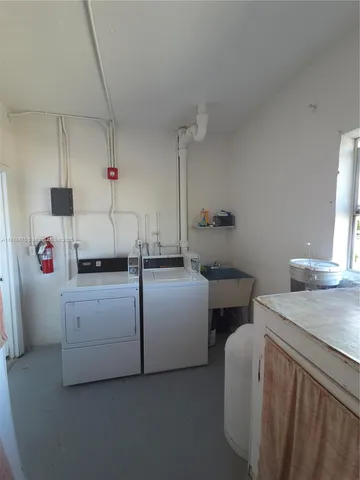 a utility room with cabinets washer and dryer