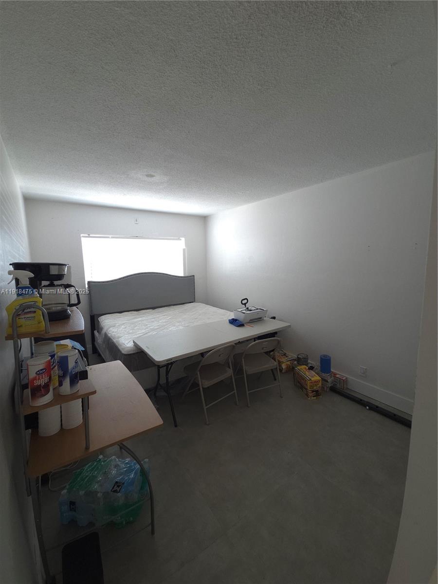 467 Golden Isles Drive, Unit 110 Hallandale Beach, FL 33009 - Photo 9 of 11 a room with furniture and gym equipment