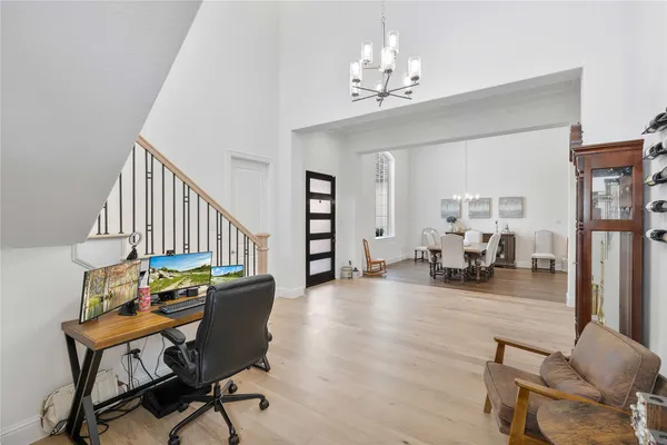 a view of entryway and workspace with wooden floor