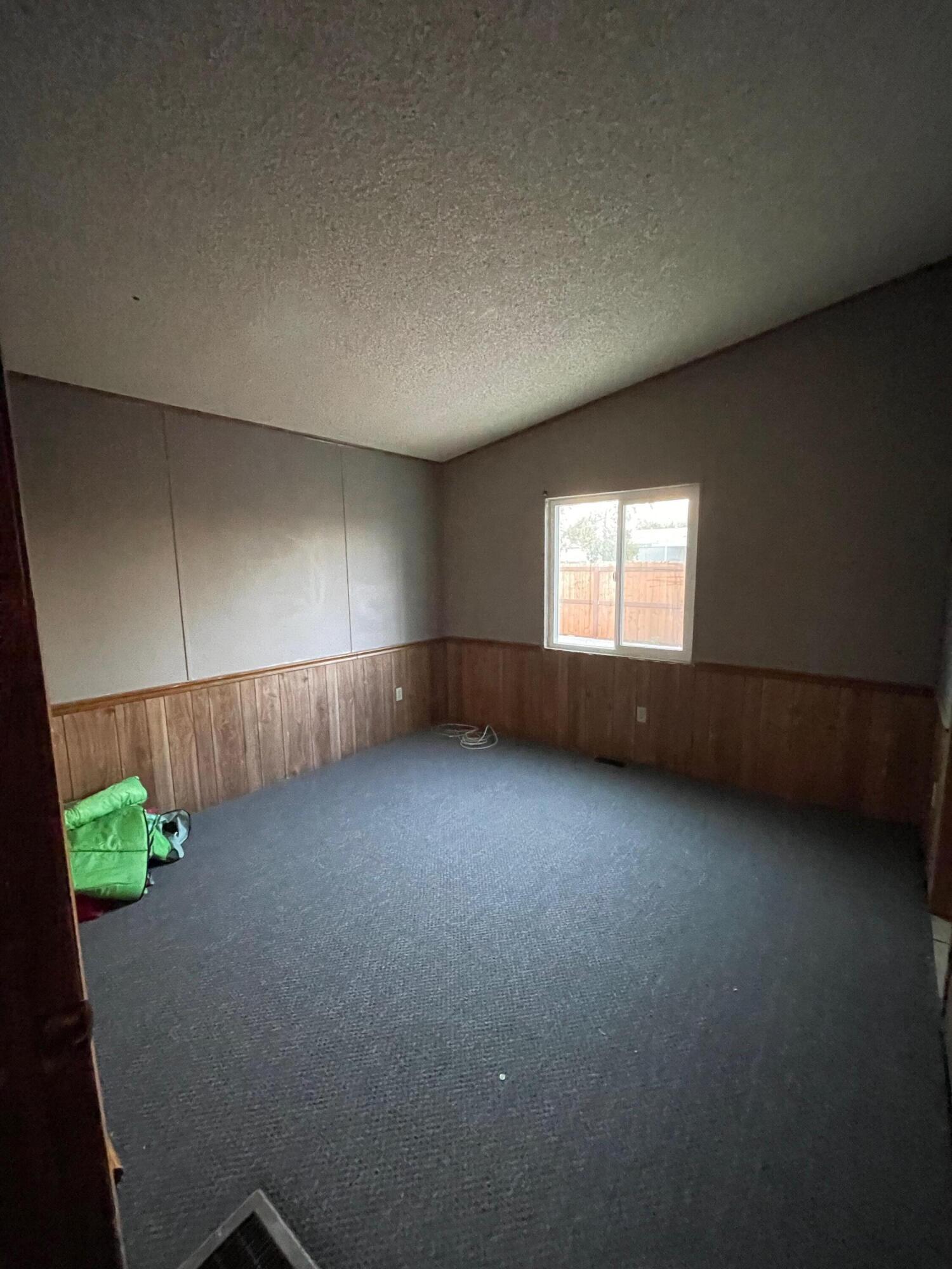 32142 Wells Fargo Road Thousand Palms, CA 92276 - Photo 19 of 25 a view of an empty room with a window and a kitchen