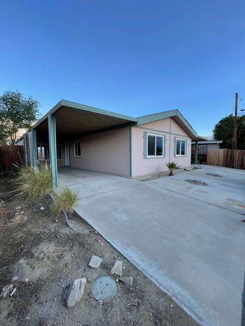 32142 Wells Fargo Road Thousand Palms, CA 92276 - Photo 2 of 25 a front view of a house with a yard