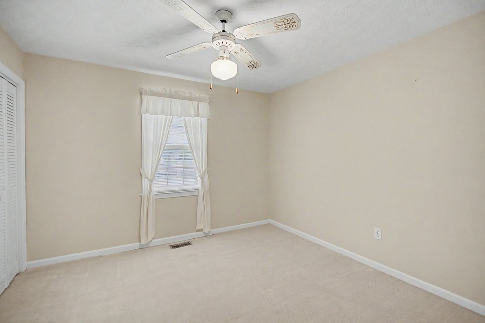 115 Brunson Drive Pickens, SC 29671 - Photo 14 of 29 Well-lit room features soft carpeting, a window, and a ceiling fan for comfort.