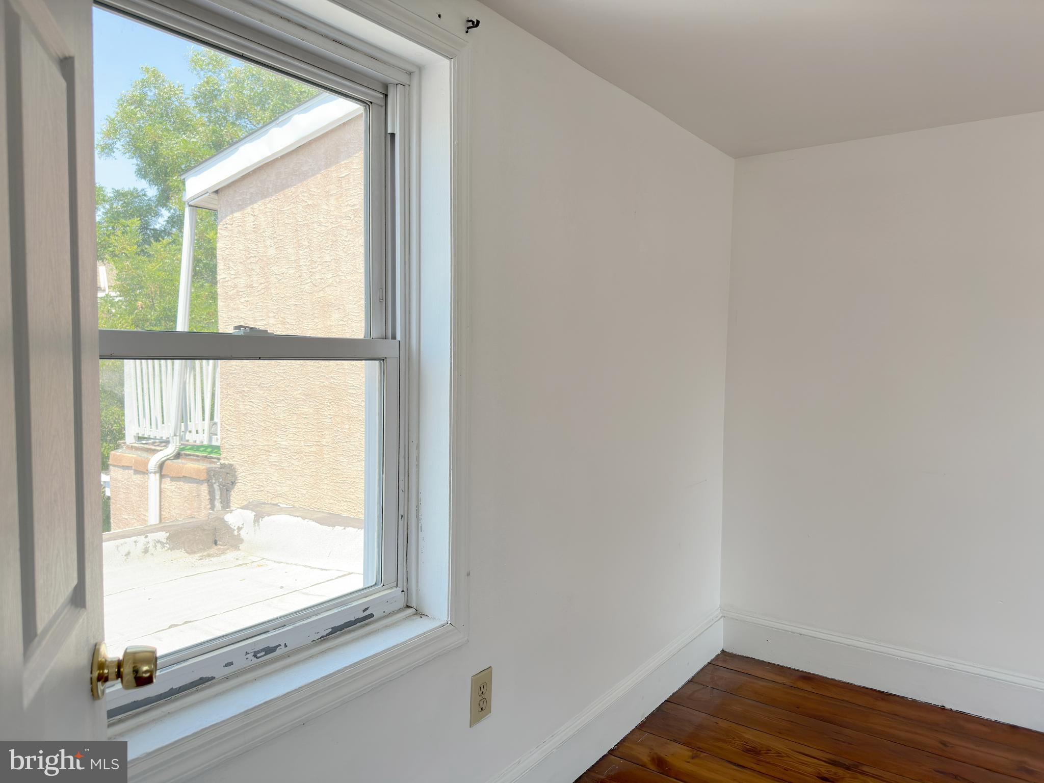 1232 North Hancock Street Philadelphia, PA 19122 - Photo 20 of 44 a view of an empty room and wooden floor and a window