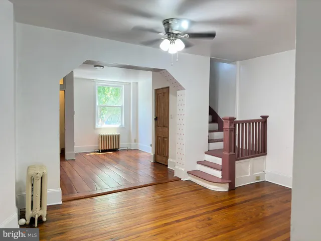 a view of an empty room and wooden floor