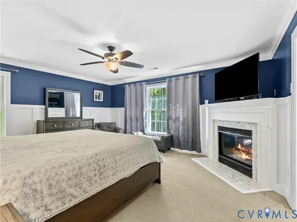 a bedroom with a large bed and a chandelier