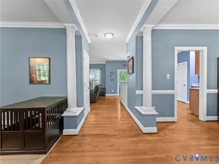 a open kitchen with stainless steel appliances granite countertop a stove refrigerator a dining table and chairs with wooden floor