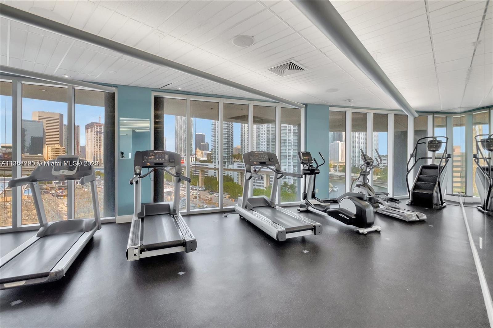 185 Southwest 7th Street, Unit 2204 Miami, FL 33130 - Photo 18 of 29 a room with gym equipment and large windows
