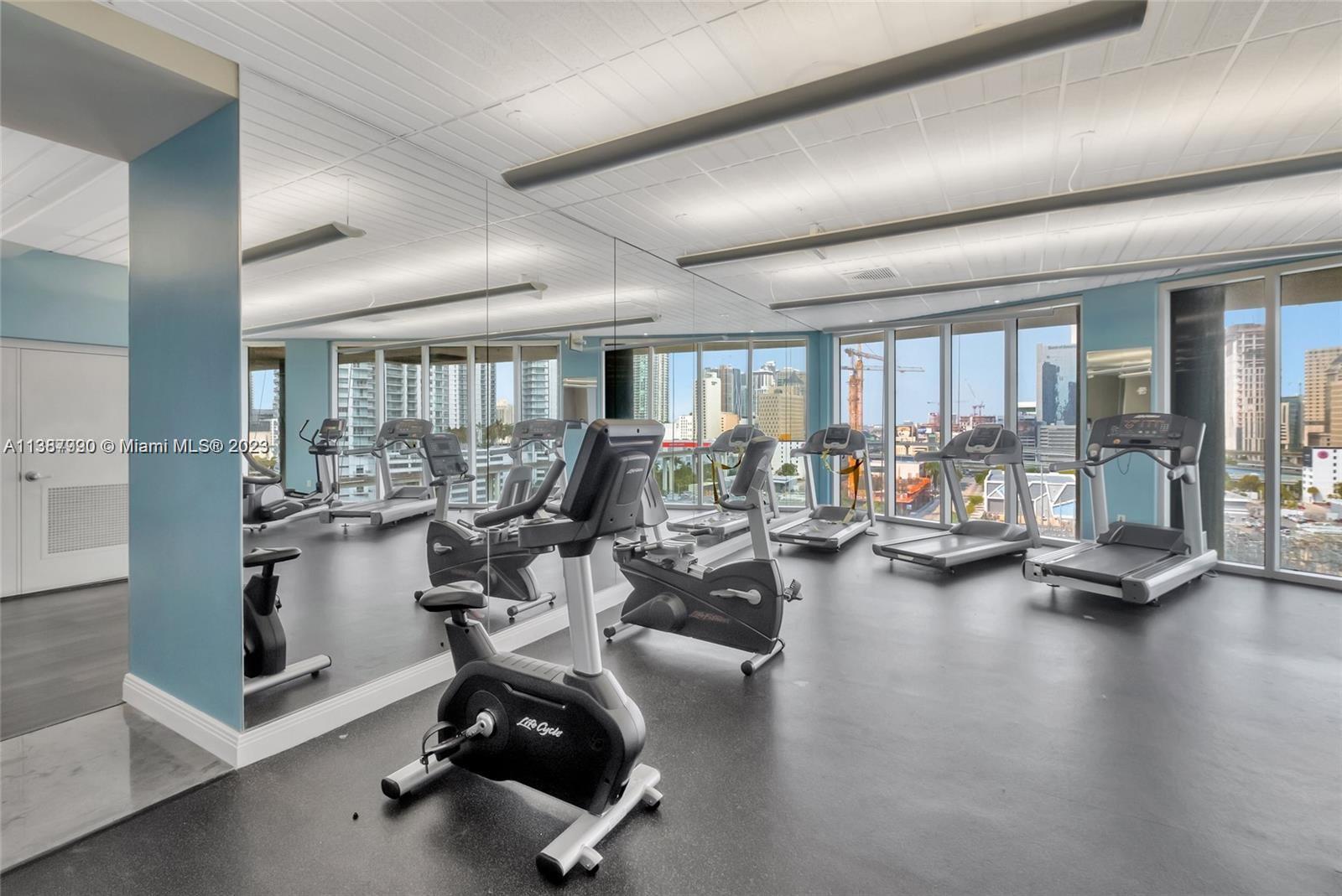 185 Southwest 7th Street, Unit 2204 Miami, FL 33130 - Photo 19 of 29 a room with gym equipment and a large window