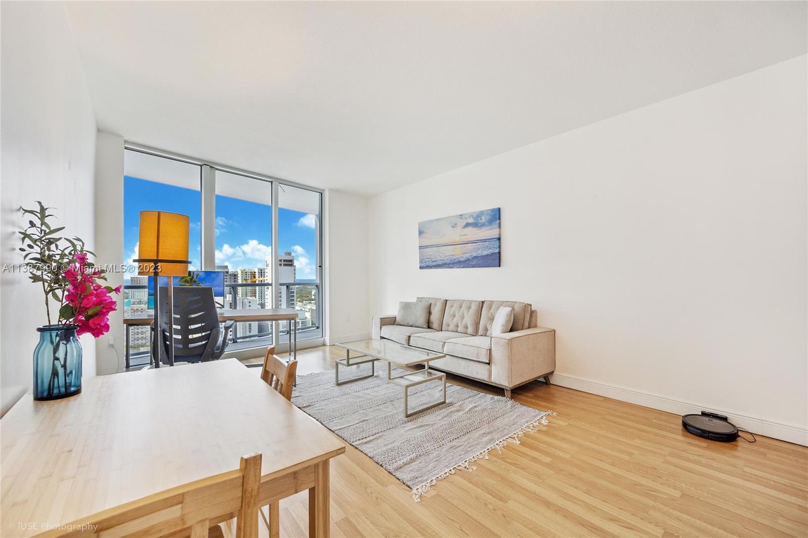 185 Southwest 7th Street, Unit 2204 Miami, FL 33130 - Photo 2 of 29 a living room with furniture and wooden floor