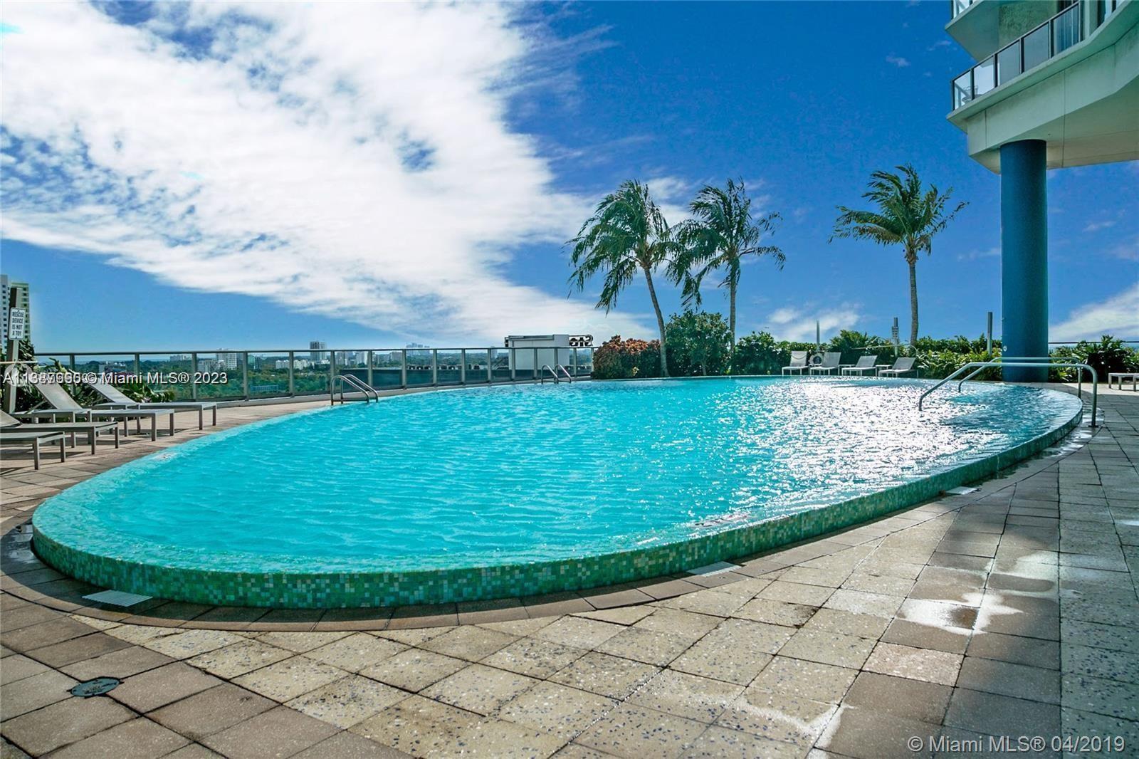 185 Southwest 7th Street, Unit 2204 Miami, FL 33130 - Photo 22 of 29 a view of a swimming pool with a yard