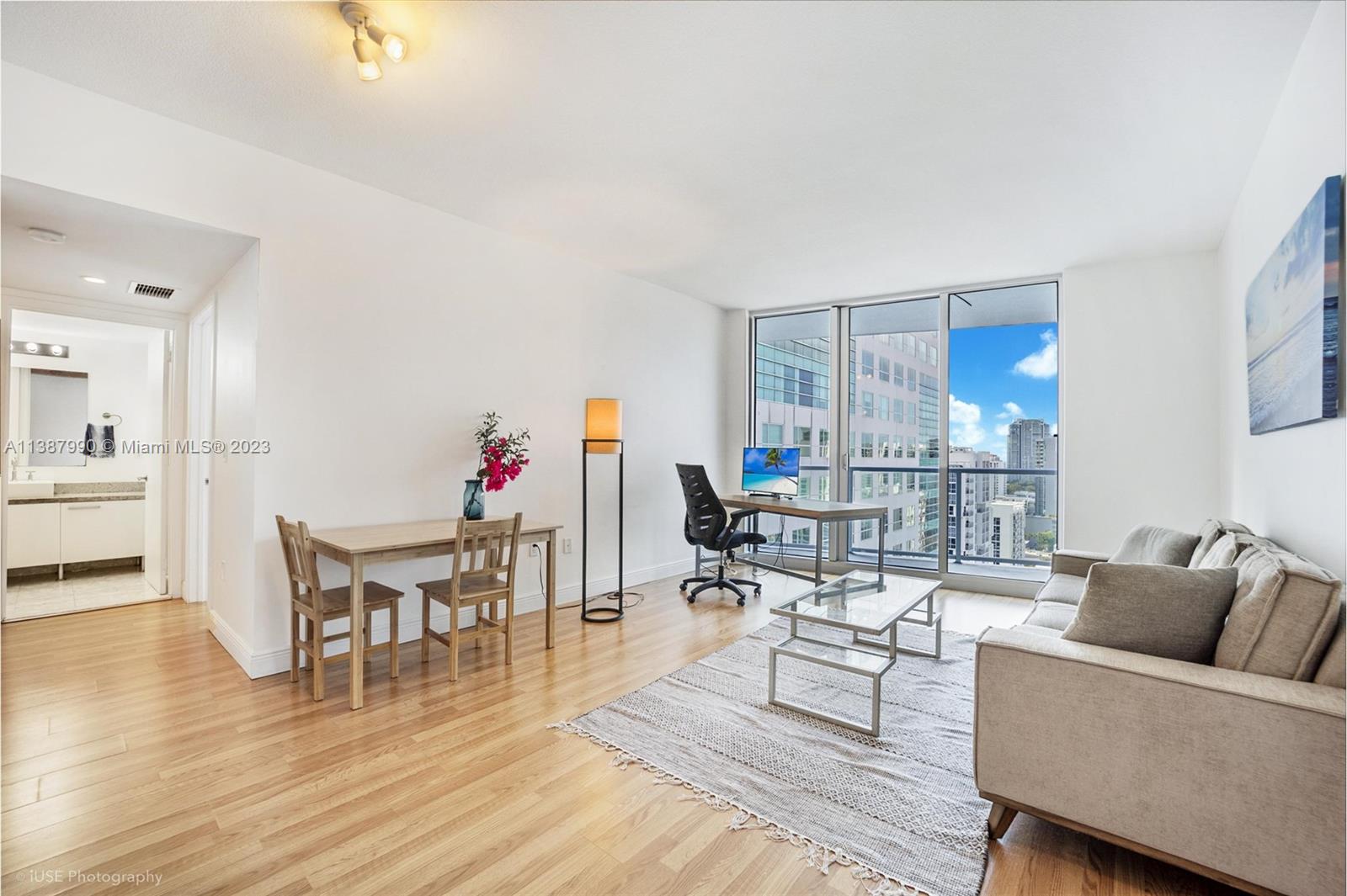 185 Southwest 7th Street, Unit 2204 Miami, FL 33130 - Photo 5 of 29 a living room with furniture and a wooden floor