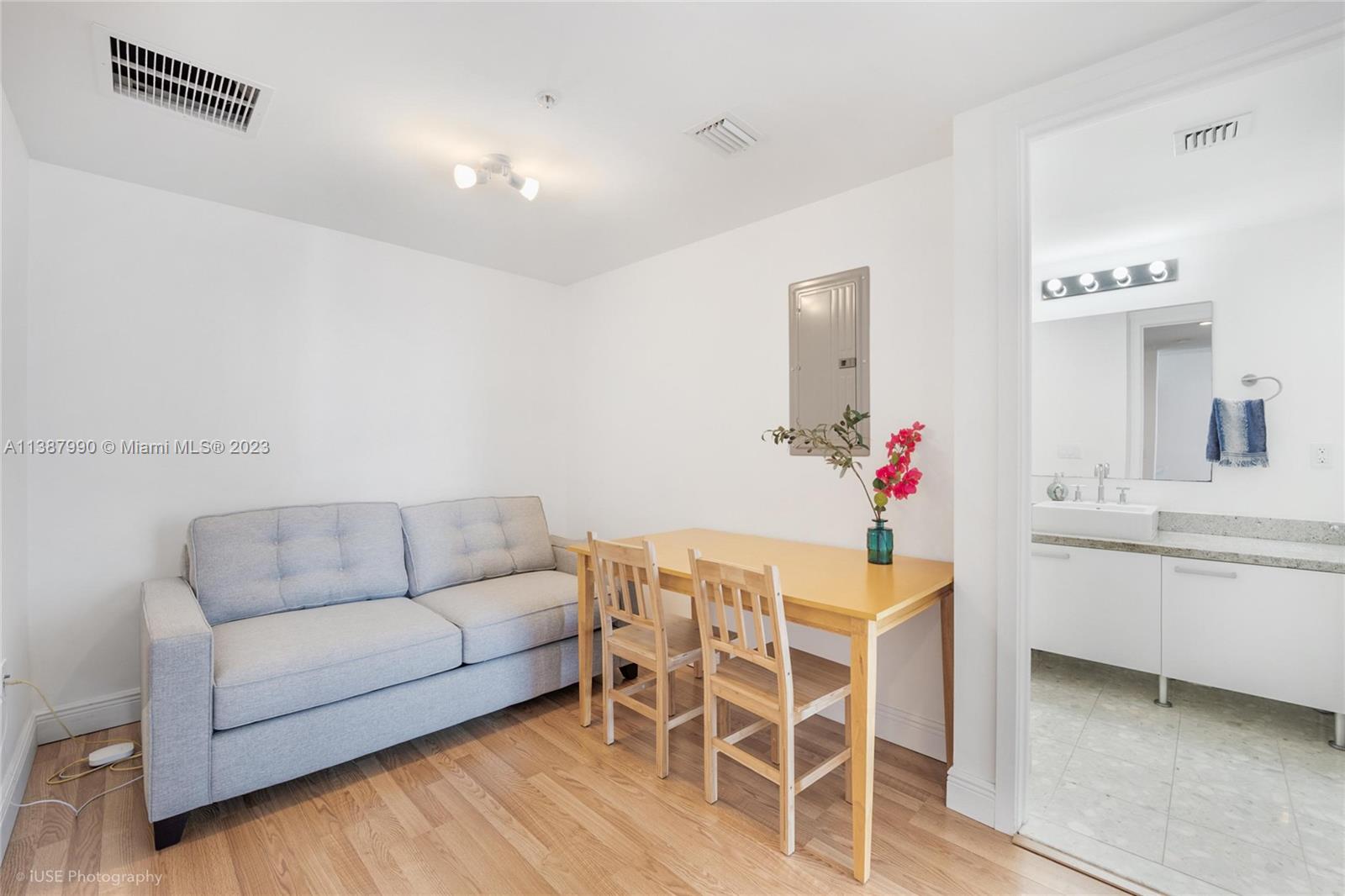 185 Southwest 7th Street, Unit 2204 Miami, FL 33130 - Photo 8 of 29 a living room with furniture and a dining table with wooden floor