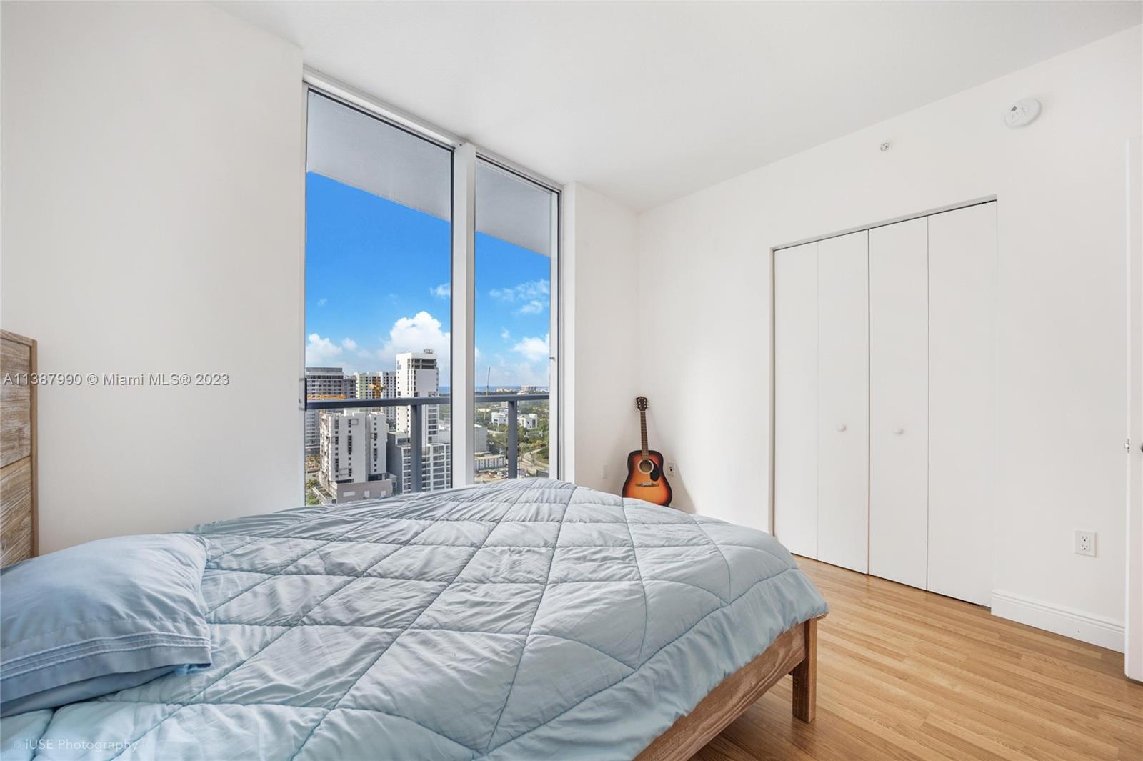 185 Southwest 7th Street, Unit 2204 Miami, FL 33130 - Photo 9 of 29 a bed sitting in a bedroom next to a window