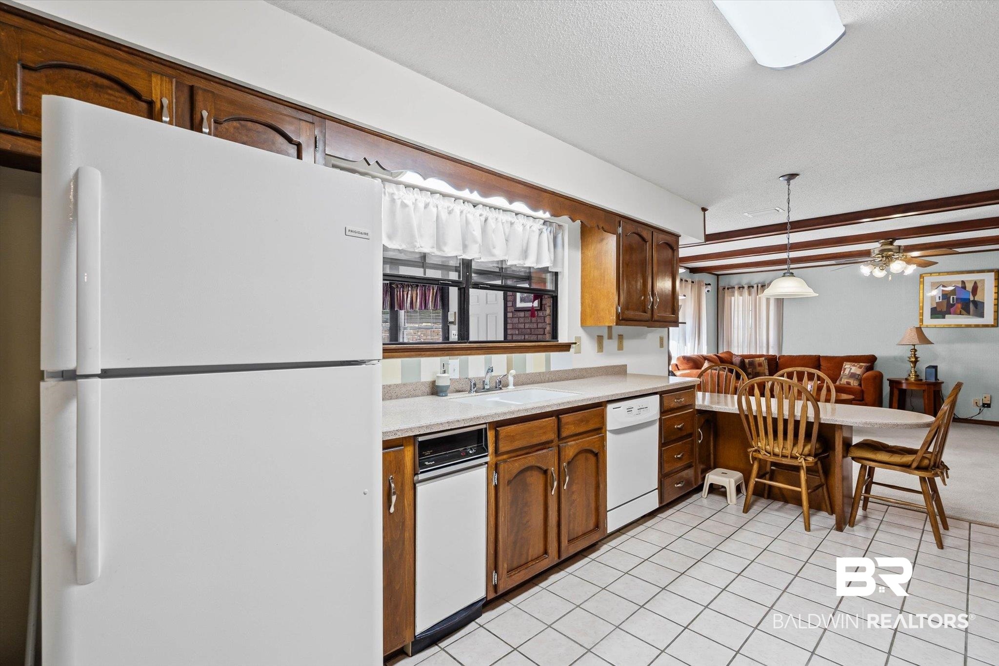 1900 Foxfire Road Mobile, AL 36618 - Photo 11 of 36 Kitchen with white appliances, light tile patterned floors, light countertops, a textured ceiling, and ceiling fan