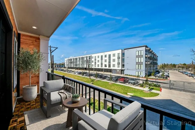 a view of a chairs and table in the balcony