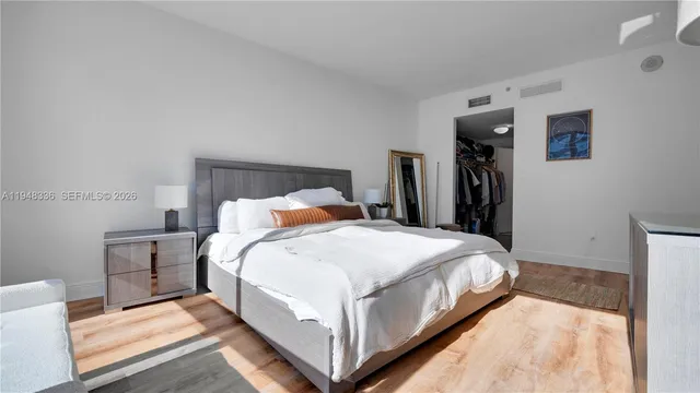 a bed room with a bed and a night stand