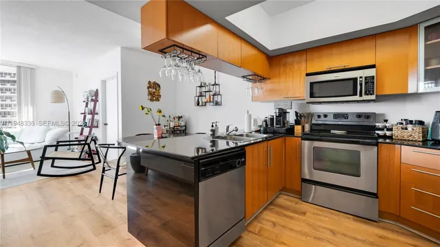 a kitchen with stainless steel appliances granite countertop a stove and a refrigerator