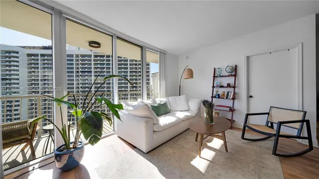 a living room with furniture and a potted plant