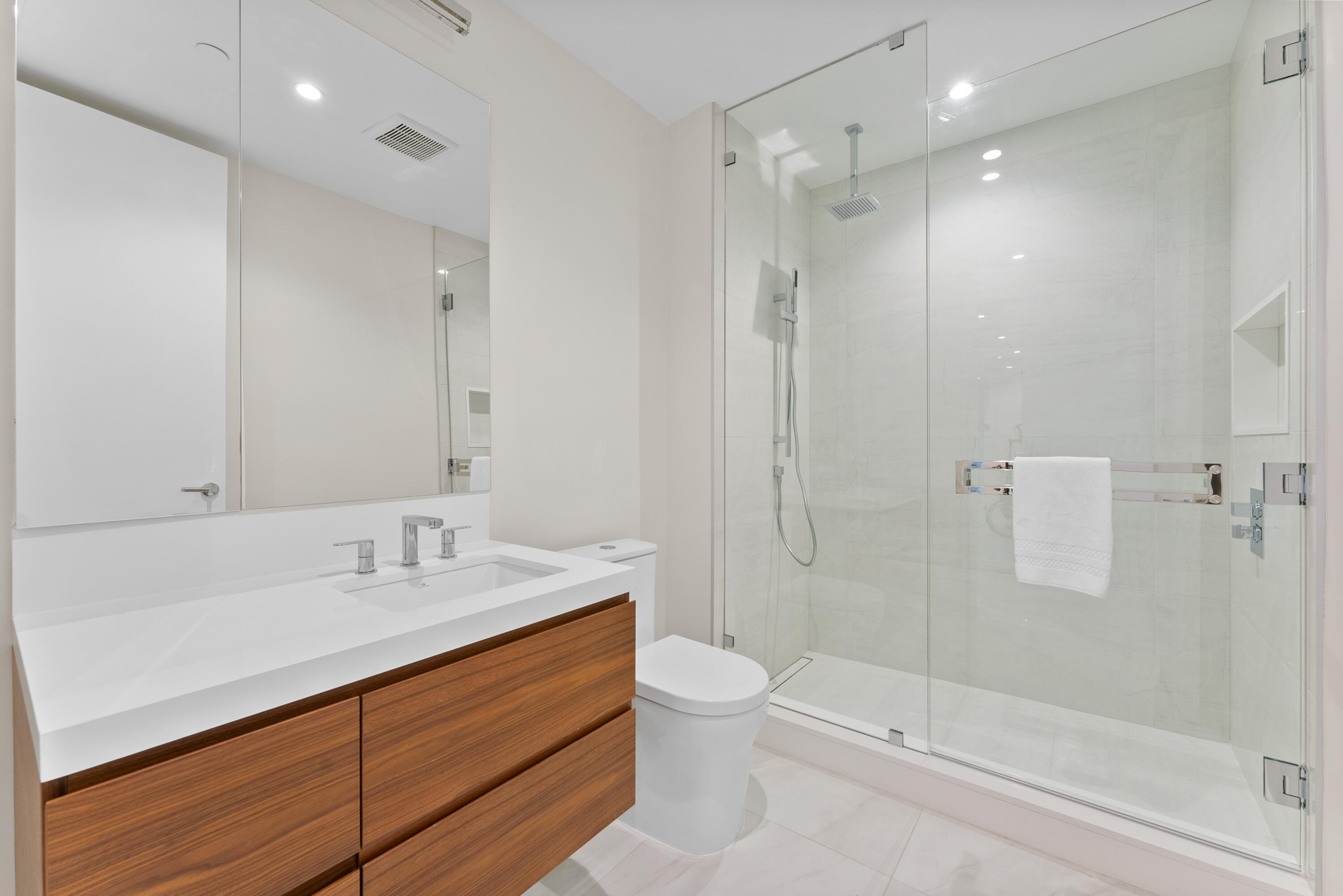 210 Southeast Mizner Boulevard, Unit 301 Boca Raton, FL 33432 - Photo 24 of 66 a bathroom with a sink a toilet and shower