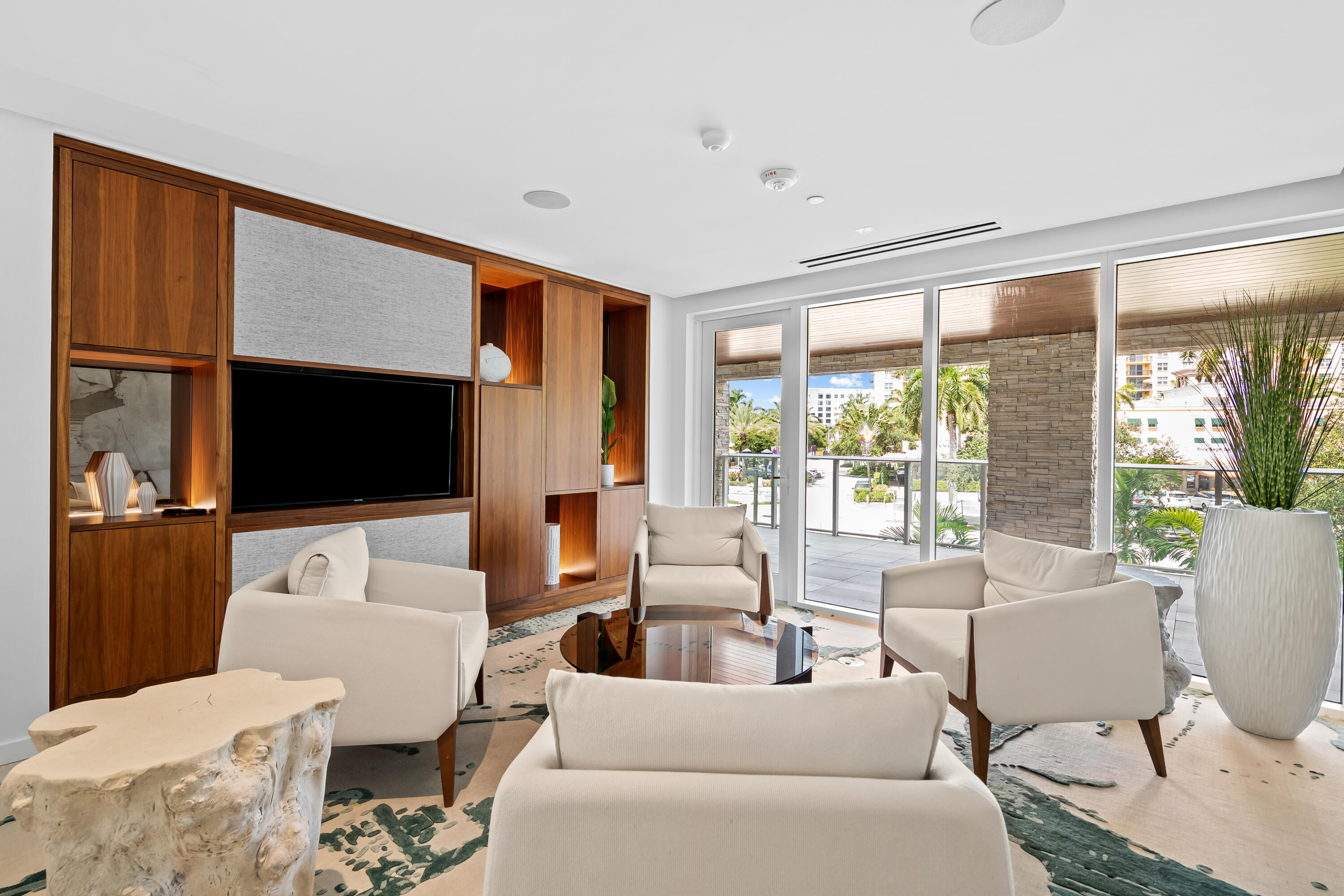 210 Southeast Mizner Boulevard, Unit 301 Boca Raton, FL 33432 - Photo 54 of 66 a living room with furniture tv and large window