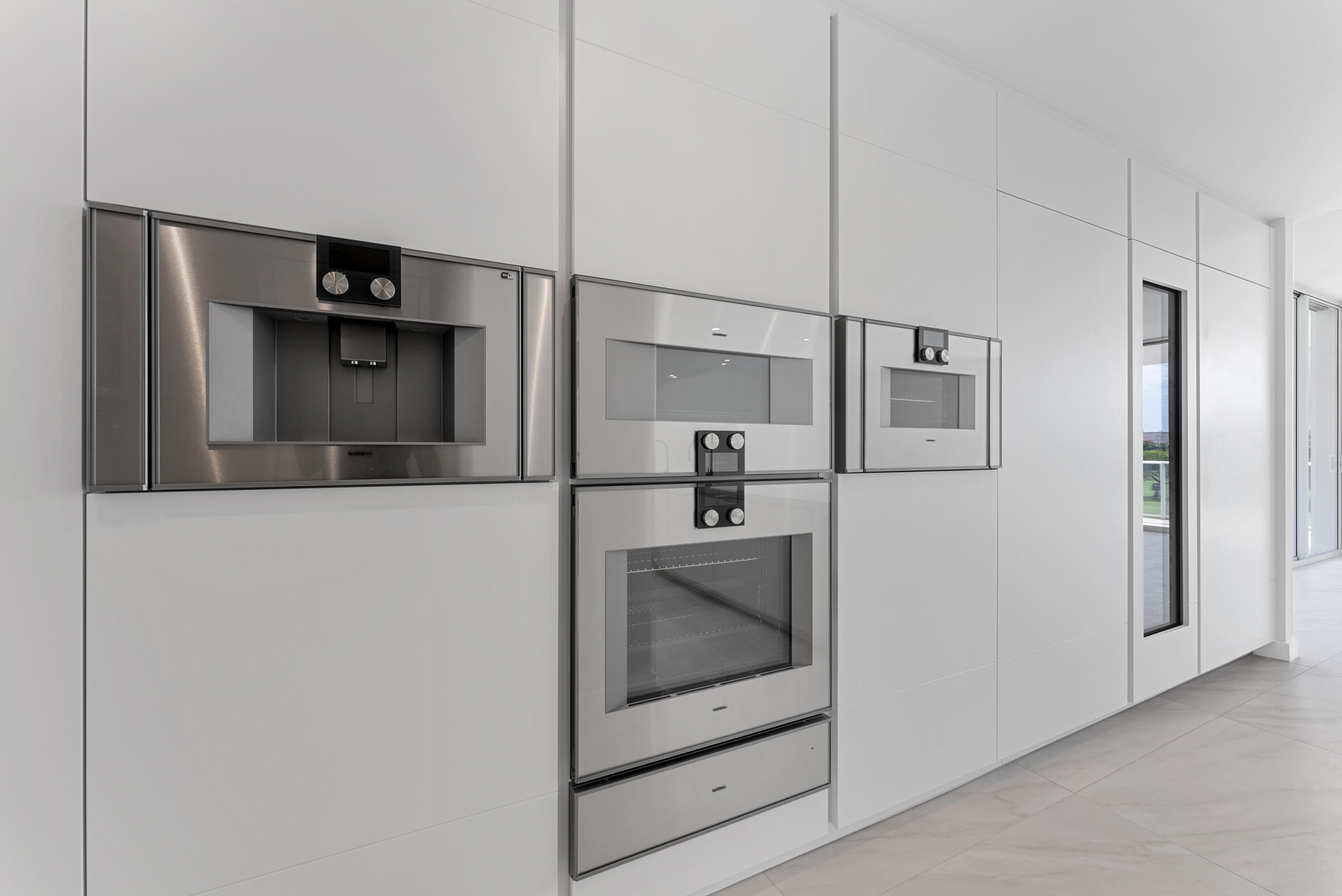 210 Southeast Mizner Boulevard, Unit 301 Boca Raton, FL 33432 - Photo 6 of 66 a kitchen with a refrigerator and a sink