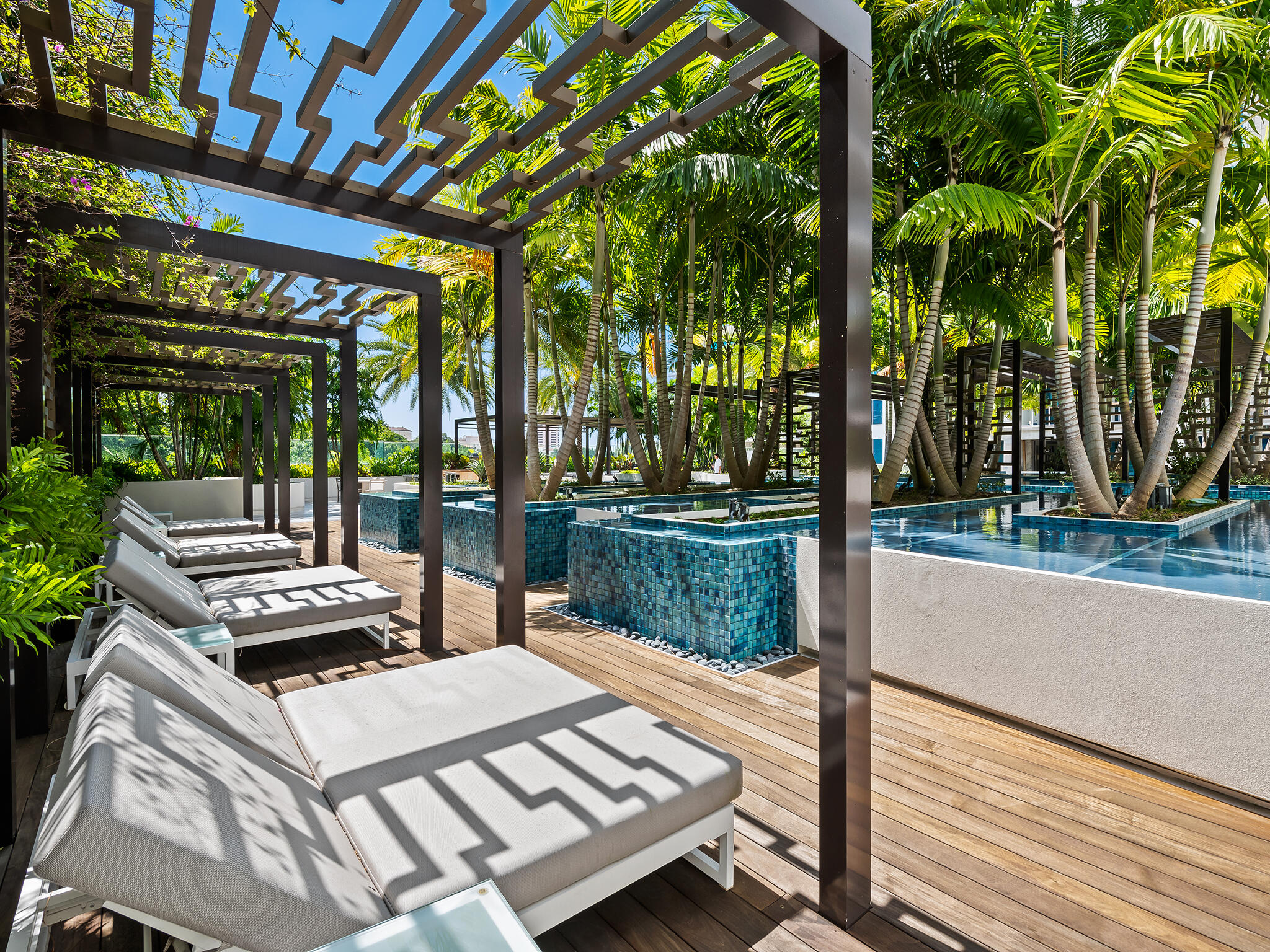 210 Southeast Mizner Boulevard, Unit 301 Boca Raton, FL 33432 - Photo 63 of 66 a view of a patio with table and chairs a barbeque with potted plants and palm trees